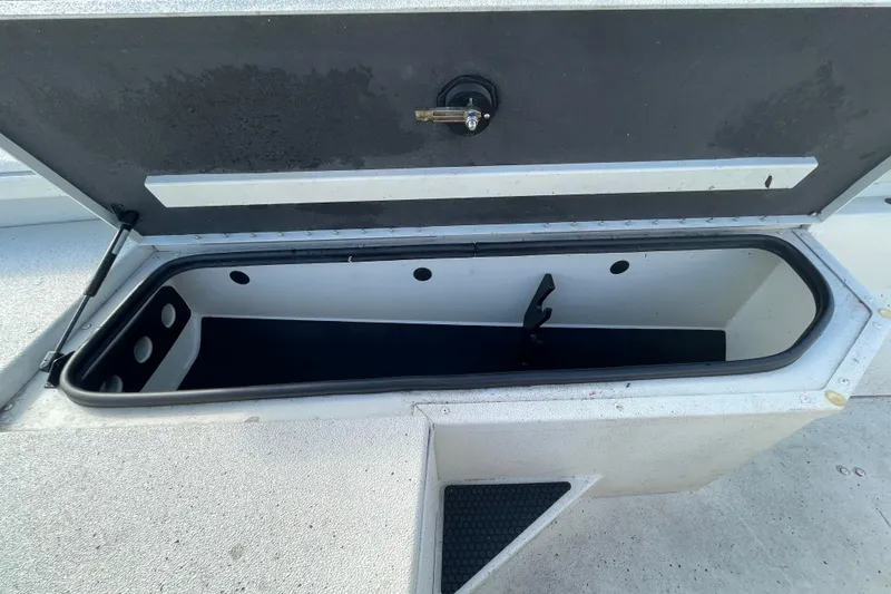 Slide: The Image of Open storage compartment in 2023 Ranger RB190 boat, showcasing interior space and design. - 38