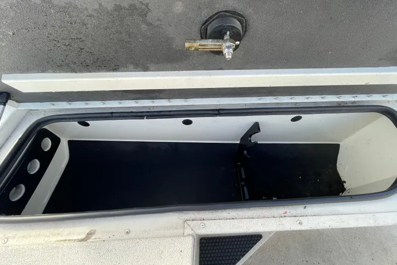 Slide: The Image of Open storage compartment in 2023 Ranger RB190 boat, featuring a clean, spacious interior. - 39