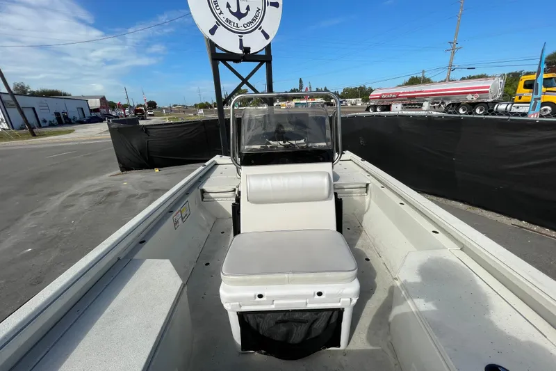 Slide: The Image of 2023 Ranger RB190 boat interior with seating, parked outdoors under clear sky. - 46
