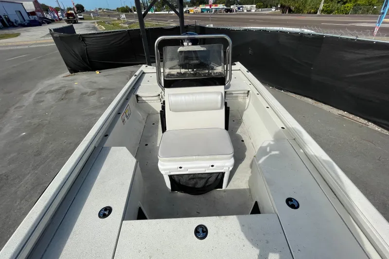 Slide: The Image of 2023 Ranger RB190 boat interior with seating and steering console, parked outdoors. - 47