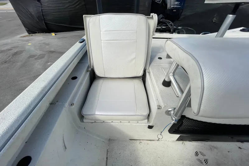 Slide: The Image of 2023 Ranger RB190 boat seat with white upholstery and storage compartment. - 55