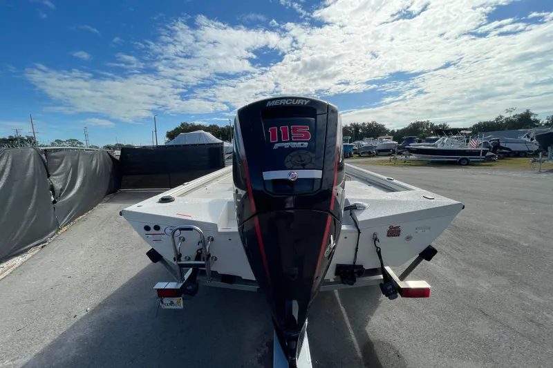 Slide: The Image of 2023 Ranger RB190 boat with Mercury 115 Pro XS engine, parked outdoors under a partly cloudy sky. - 9