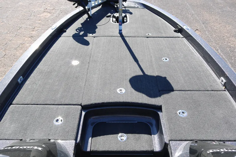 Slide: The Image of 2010 Ranger Z521 Comanche boat deck with carpeted surface and storage compartments. - 13