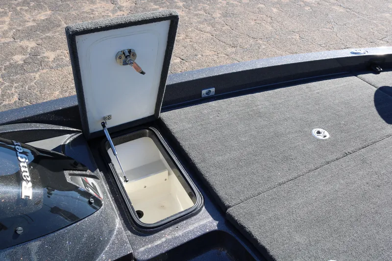 Slide: The Image of 2010 Ranger Z521 Comanche boat storage compartment open on deck. - 15