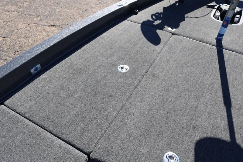 Slide: The Image of 2010 Ranger Z521 Comanche boat deck with carpeted surface and storage compartments. - 16