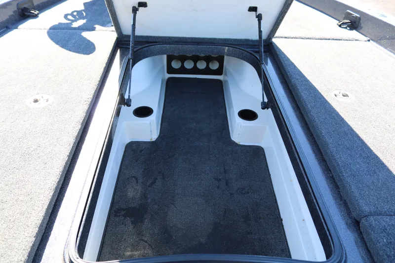 Slide: The Image of 2010 Ranger Z521 Comanche boat storage compartment with open lid and carpeted interior. - 20