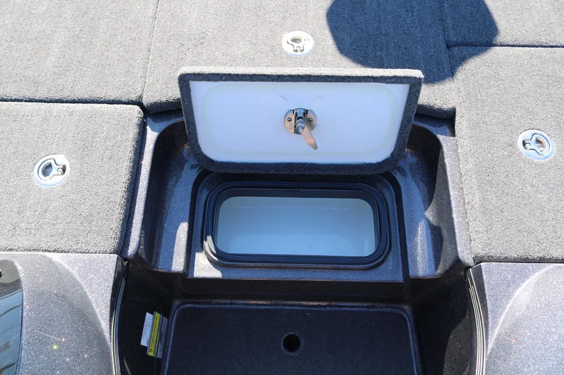 Slide: The Image of 2010 Ranger Z521 Comanche boat storage compartment with open lid, showcasing interior space. - 25