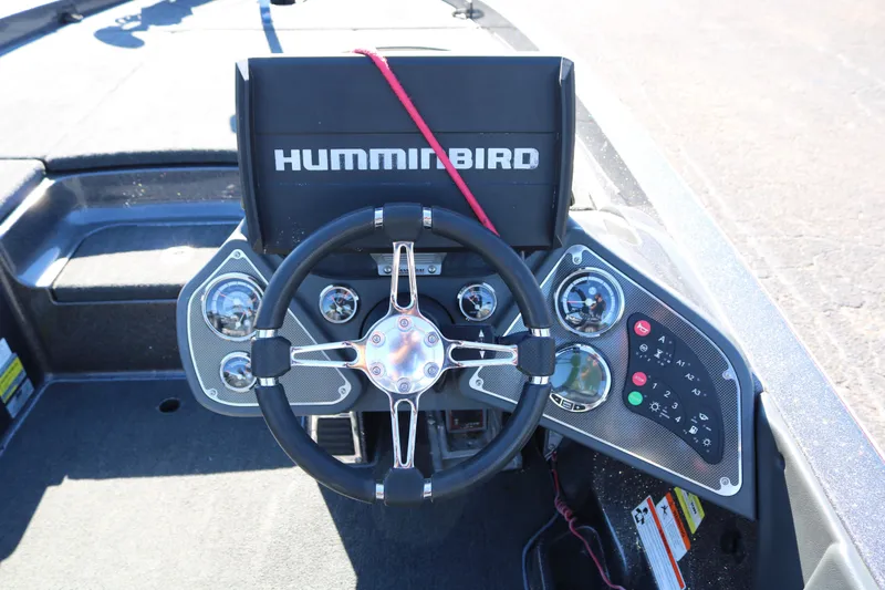 Slide: The Image of 2010 Ranger Z521 Comanche boat dashboard with Humminbird electronics and steering wheel. - 26