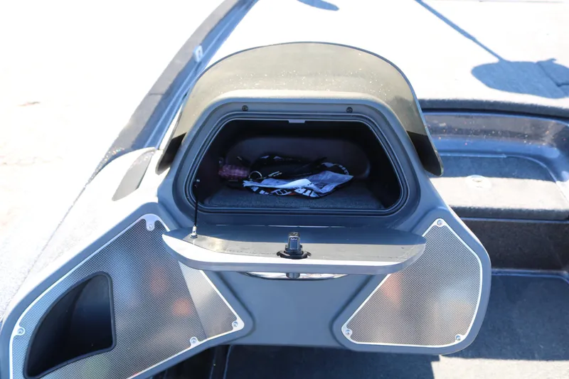 Slide: The Image of Open storage compartment on a 2010 Ranger Z521 Comanche boat, showing interior contents. - 28