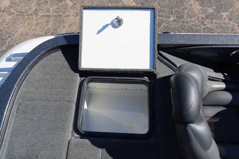 Slide: The Image of 2010 Ranger Z521 Comanche boat storage compartment with open lid and seating area. - 34