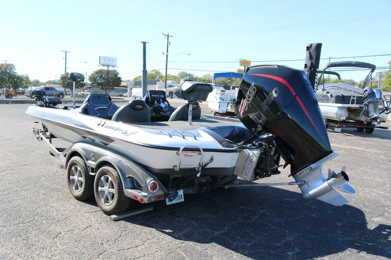 Slide: The Image of 2010 Ranger Z521 Comanche boat with powerful outboard motor in a parking lot. - 4