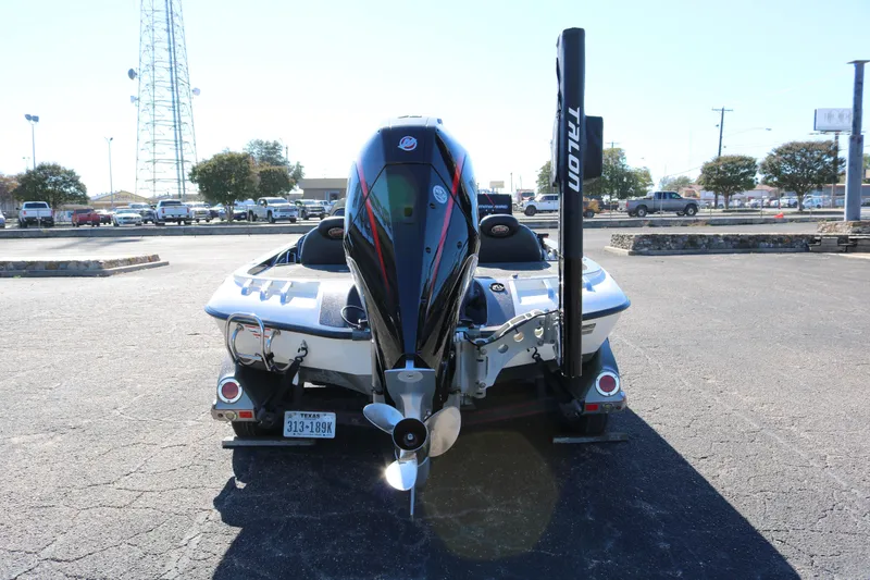 Slide: The Image of 2010 Ranger Z521 Comanche boat with powerful outboard motor in a parking lot. - 7