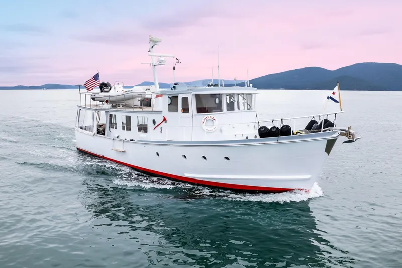 The Image of 1966 Willard Marine 47 boat cruising on calm waters at sunset. - 1