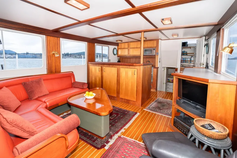 Slide: The Image of Interior of 1966 Willard Marine 47 with cozy seating and wooden cabinetry. - 12