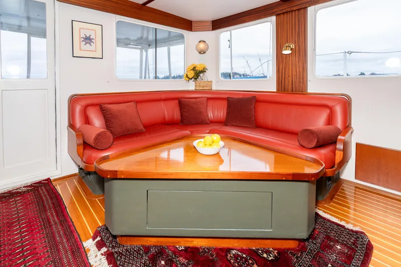 Slide: The Image of Cozy interior of 1966 Willard Marine 47 with red seating and wooden table. - 15