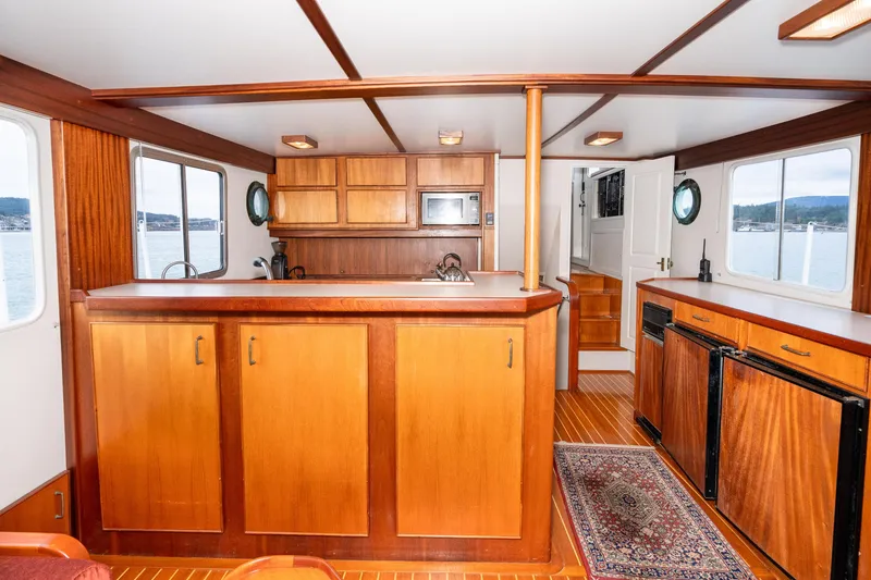 Slide: The Image of Interior of 1966 Willard Marine 47 boat with wooden cabinetry and nautical decor. - 16