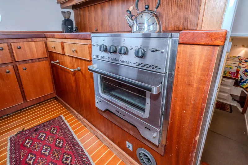 Slide: The Image of Vintage 1966 Willard Marine 47 kitchen with wooden cabinetry and Mediterranean stove. - 21