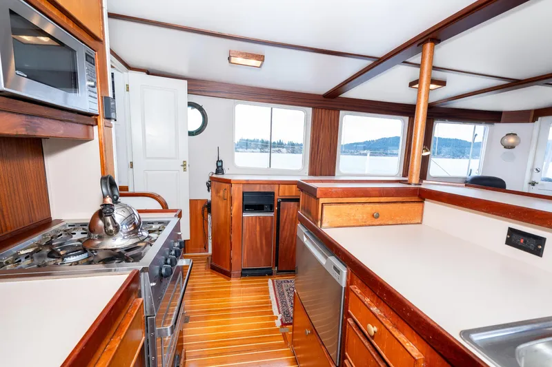 Slide: The Image of Interior of a 1966 Willard Marine 47 boat with a well-equipped kitchen. - 23