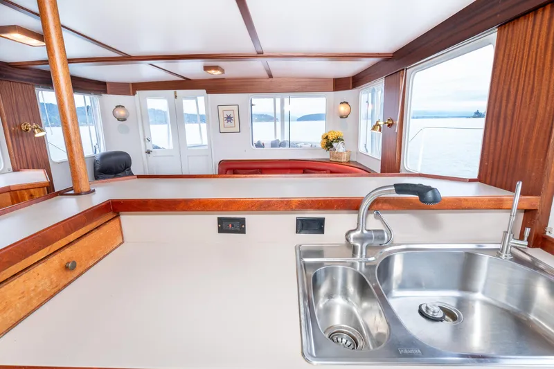 Slide: The Image of Interior of 1966 Willard Marine 47 boat with modern kitchen and scenic windows. - 24