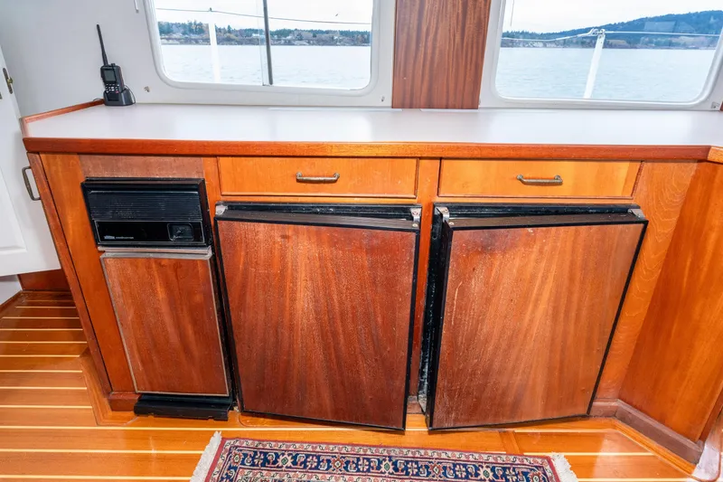 Slide: The Image of Wooden interior of 1966 Willard Marine 47 with cabinets and appliances. - 25