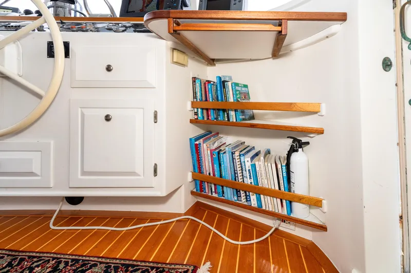 Slide: The Image of Interior of 1966 Willard Marine 47 with bookshelves and fire extinguisher. - 28
