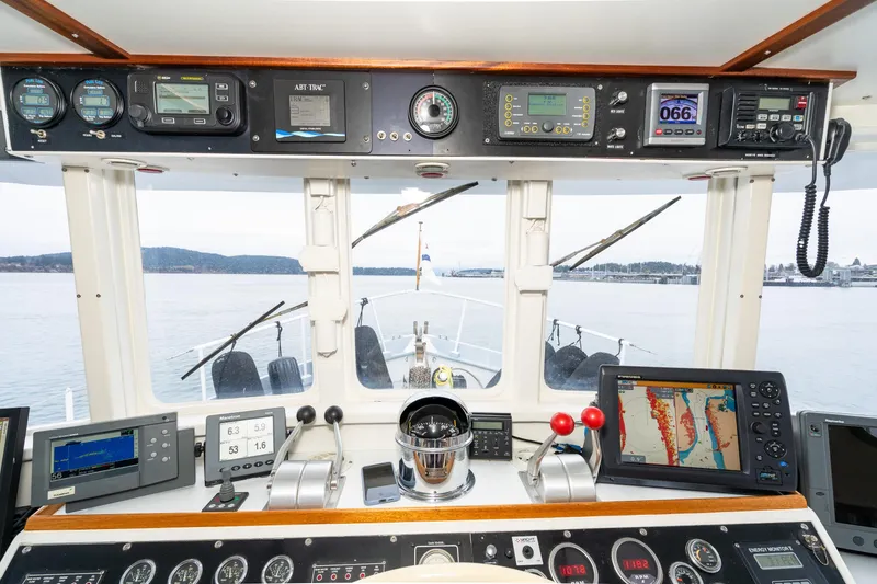 Slide: The Image of Cockpit view of 1966 Willard Marine 47 boat with navigation instruments and scenic waterway. - 37