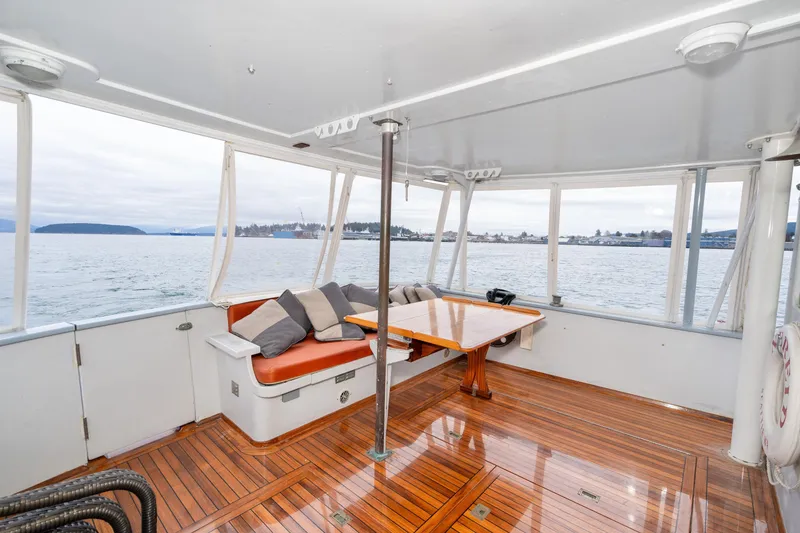 Slide: The Image of Interior of 1966 Willard Marine 47 boat with wooden flooring and cushioned seating. - 4