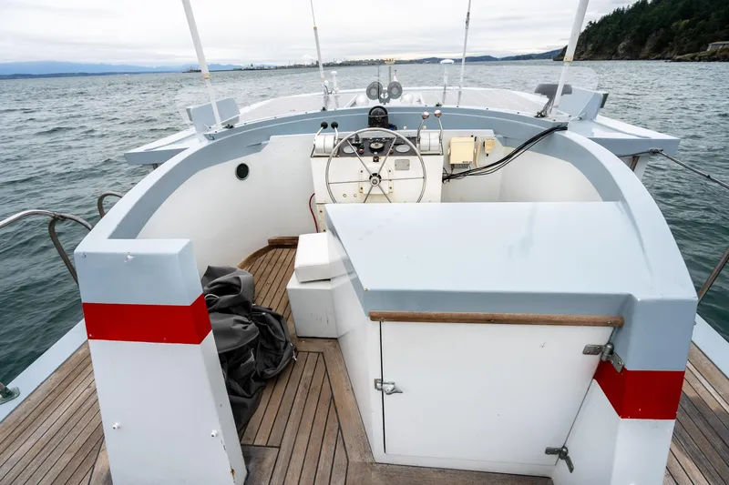 Slide: The Image of 1966 Willard Marine 47 boat cockpit with steering wheel, on open water. - 41