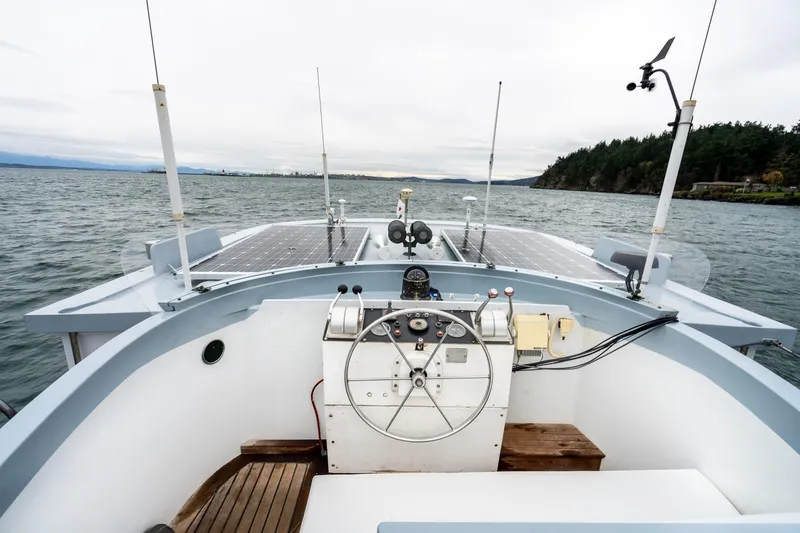 Slide: The Image of 1966 Willard Marine 47 boat with solar panels on open water. - 42