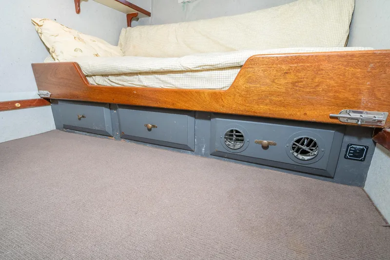 Slide: The Image of Interior of a 1966 Willard Marine 47, featuring a wooden bench with storage and ventilation. - 49