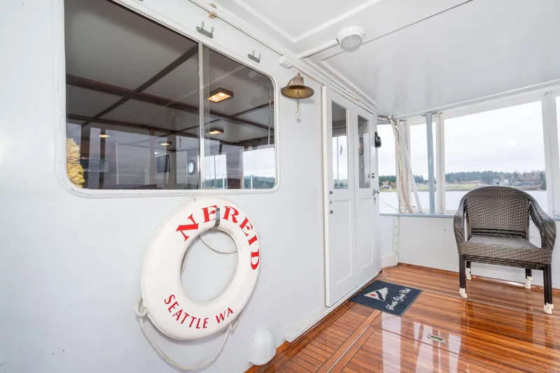 Slide: The Image of Interior of 1966 Willard Marine 47 boat with life preserver and wicker chair. - 5