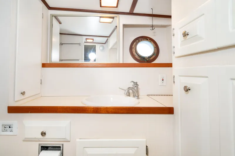Slide: The Image of Bathroom interior of 1966 Willard Marine 47 with porthole and sink. - 53