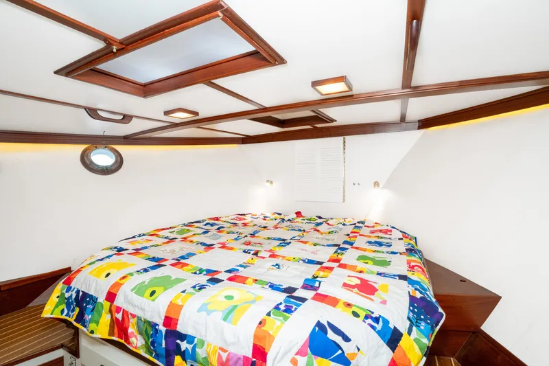Slide: The Image of Cozy cabin interior of 1966 Willard Marine 47 with colorful quilted bedspread. - 56