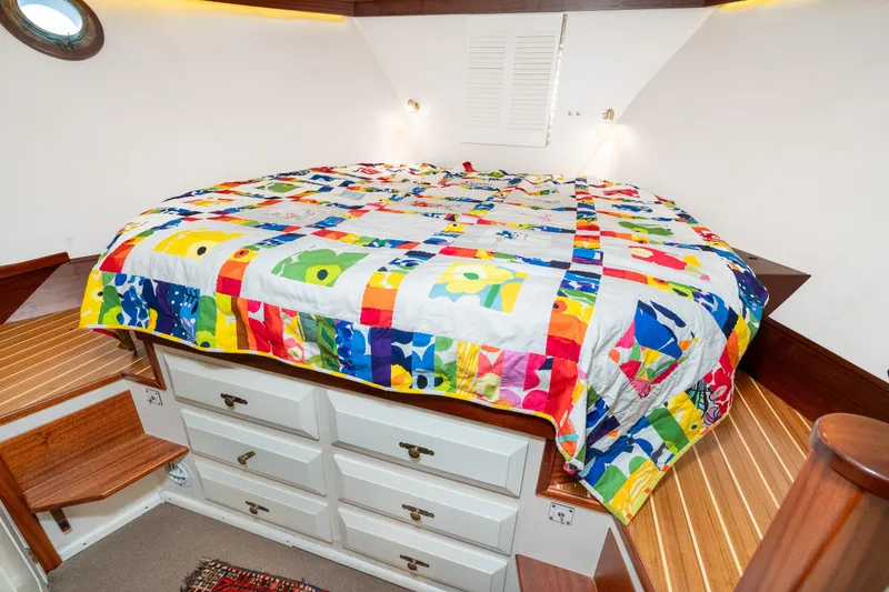 Slide: The Image of Cozy cabin interior of 1966 Willard Marine 47 with colorful quilted bedspread. - 57