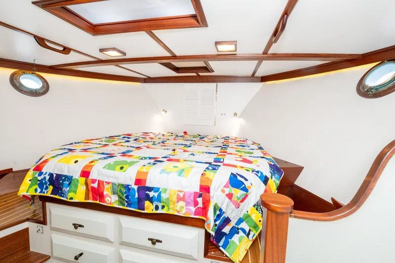 Slide: The Image of Cozy cabin interior of 1966 Willard Marine 47 with colorful quilt and wooden accents. - 58
