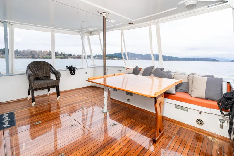 Slide: The Image of Spacious deck of 1966 Willard Marine 47 with wooden flooring and scenic water views. - 6