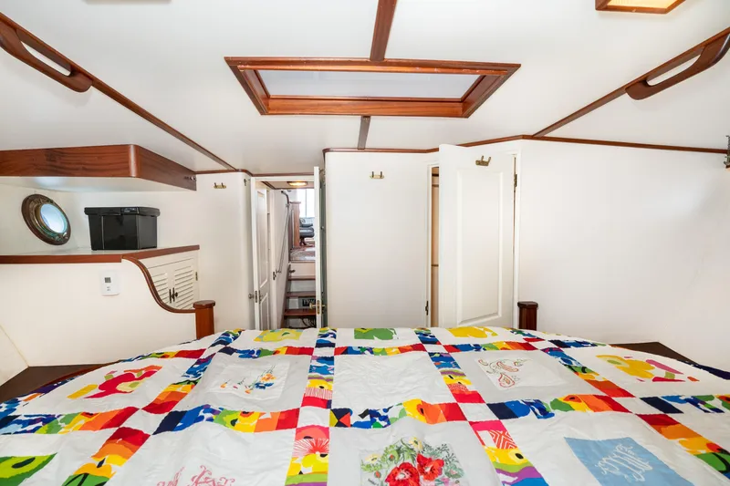 Slide: The Image of Cozy cabin interior of 1966 Willard Marine 47 with colorful quilt and wooden accents. - 60