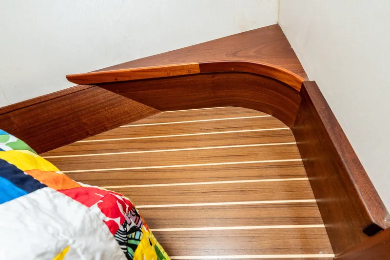 Slide: The Image of Wooden interior detail of a 1966 Willard Marine 47 boat with colorful bedding. - 62