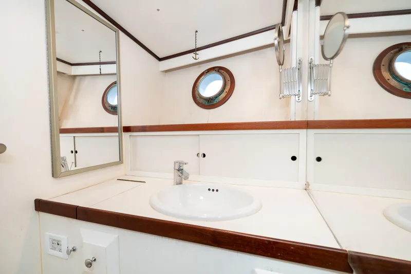 Slide: The Image of Bathroom interior of 1966 Willard Marine 47 boat with porthole windows and sink. - 64