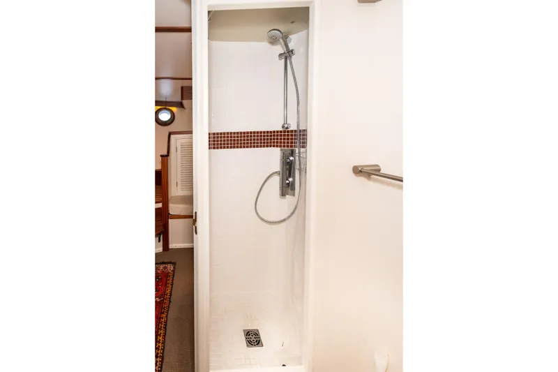 Slide: The Image of Shower area in 1966 Willard Marine 47 boat with modern fixtures and tiled accents. - 65