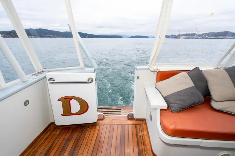 Slide: The Image of Interior view of 1966 Willard Marine 47 boat with cushions and ocean backdrop. - 7