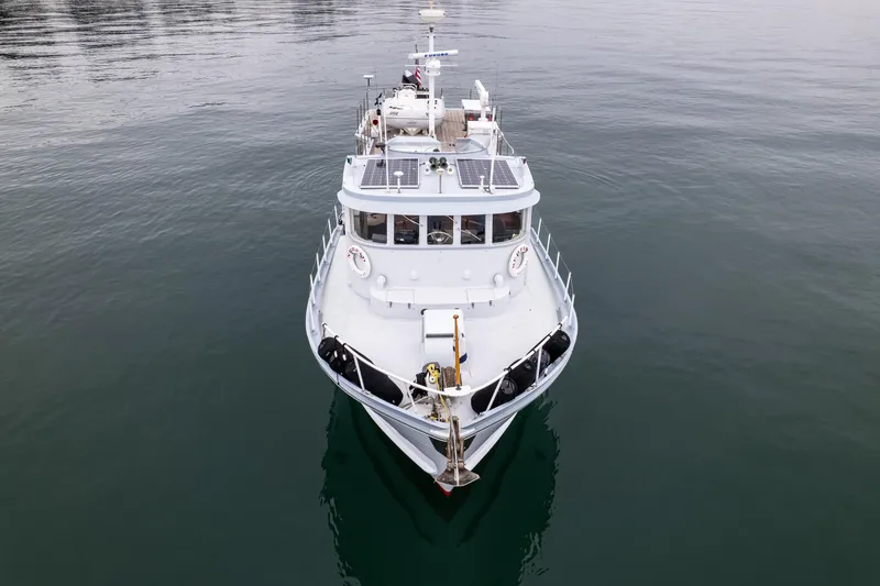 Slide: The Image of Front view of a 1966 Willard Marine 47 boat on calm water. - 72
