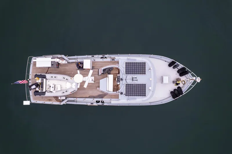 Slide: The Image of Aerial view of 1966 Willard Marine 47 boat with solar panels and American flag. - 74