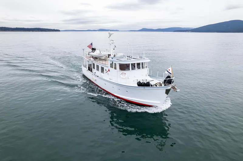 Slide: The Image of 1966 Willard Marine 47 boat cruising on calm waters under cloudy skies. - 76