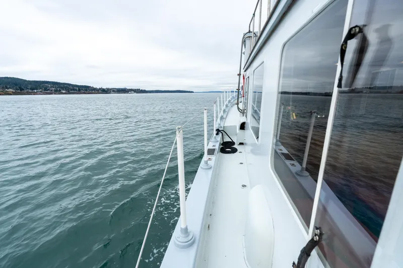 Slide: The Image of 1966 Willard Marine 47 boat cruising on calm waters under cloudy skies. - 77