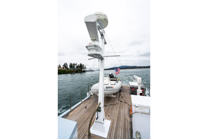 Slide: The Image of 1966 Willard Marine 47 boat deck with radar and American flag on water. - 79