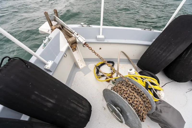 Slide: The Image of Deck of 1966 Willard Marine 47 boat with anchor chain and fenders. - 86