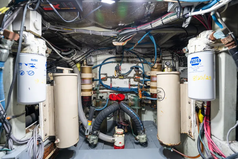 Slide: The Image of Engine room of a 1966 Willard Marine 47, showcasing filters and wiring. - 89