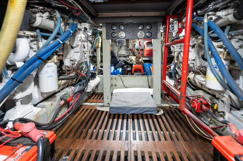 Slide: The Image of Engine room of a 1966 Willard Marine 47, showcasing complex machinery and wiring. - 90