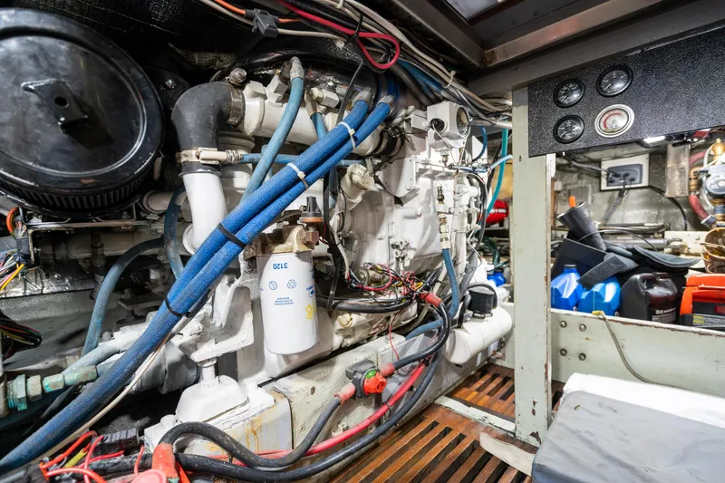 Slide: The Image of Engine room of a 1966 Willard Marine 47 boat, showcasing mechanical components and wiring. - 92